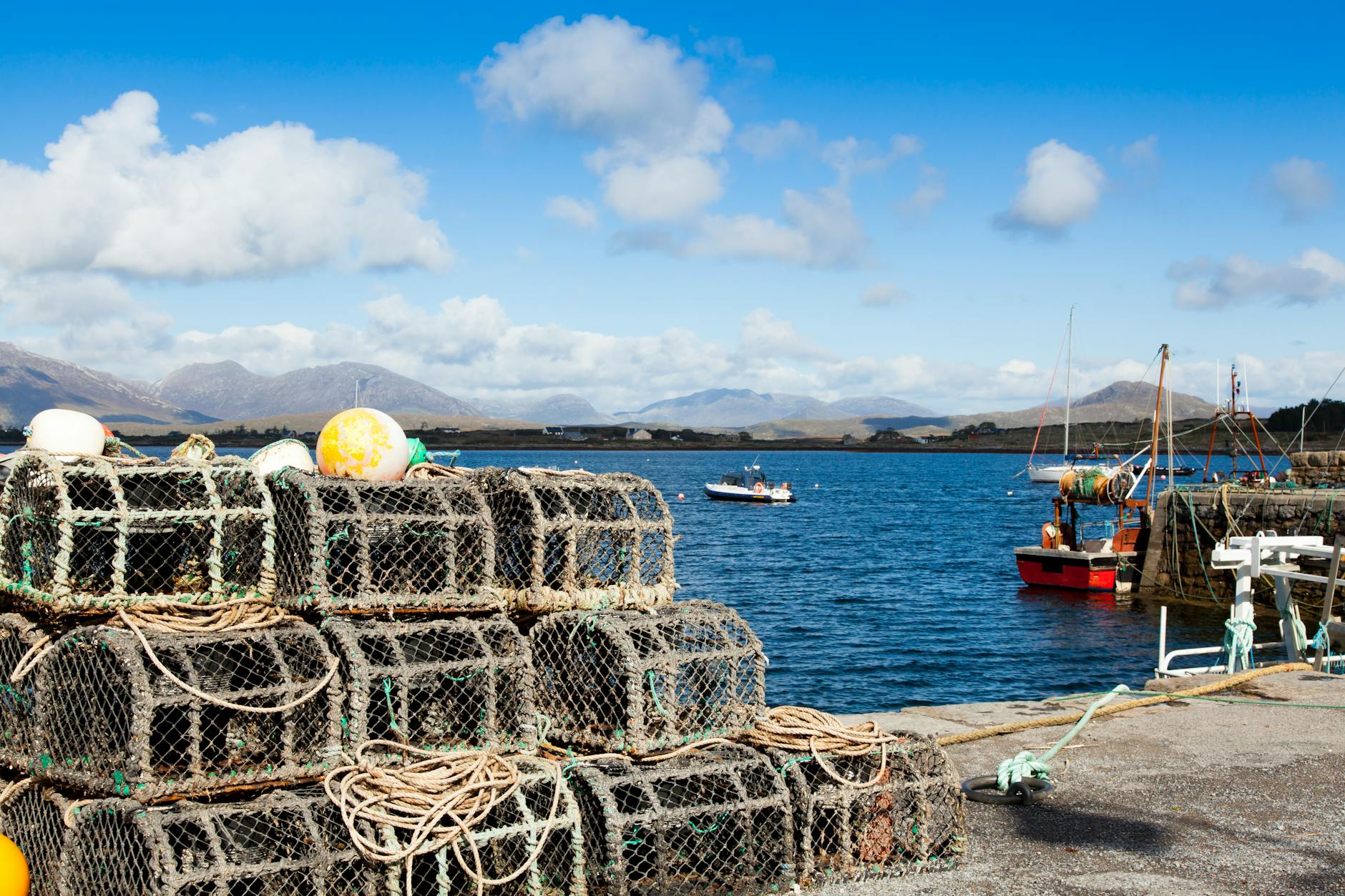 idyllic irish fishing harbor with lobster pots