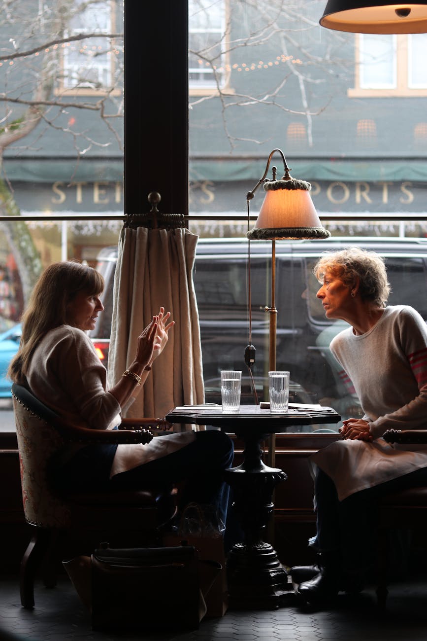 two women conversing in cozy new york cafe